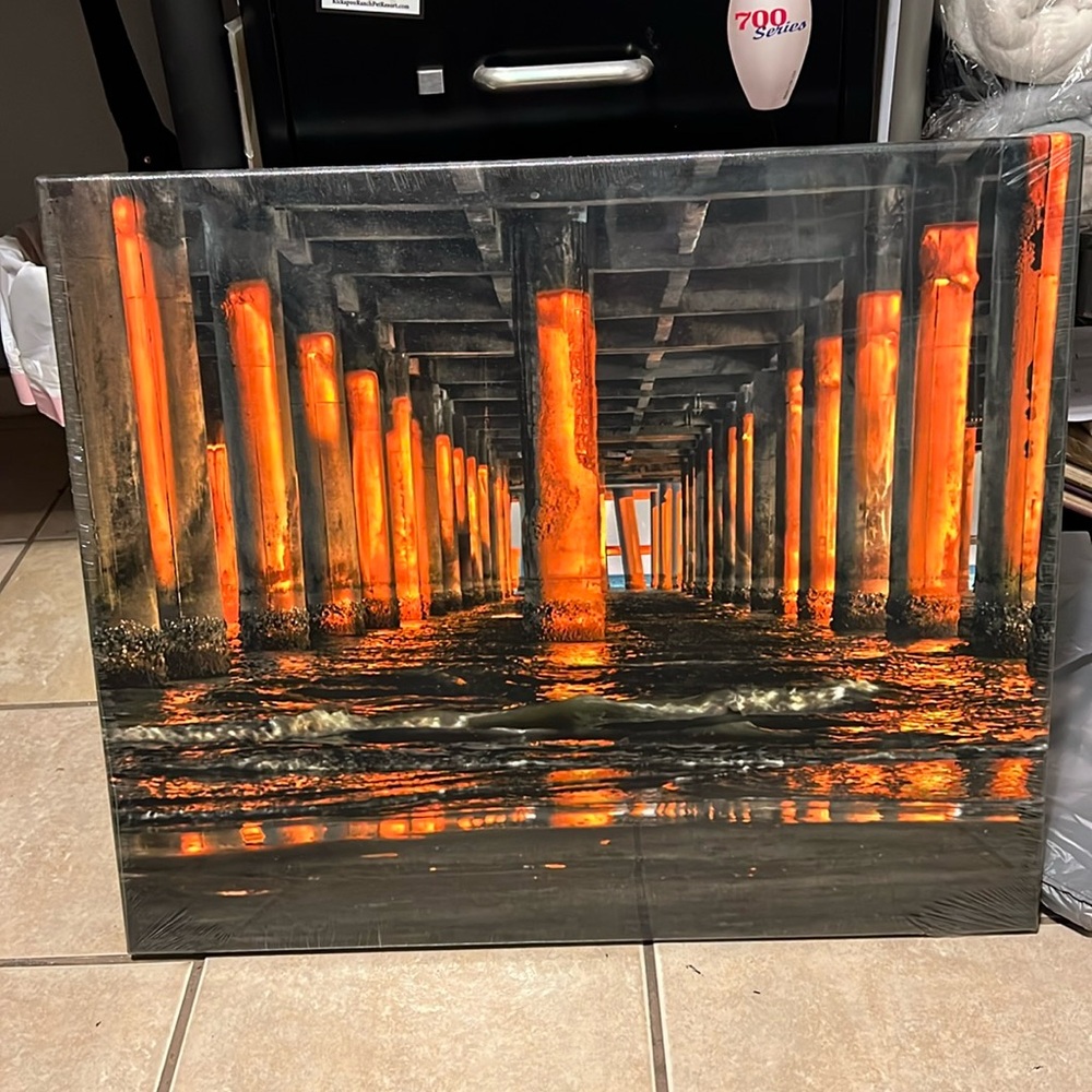 A One of Kind photo on Canvas under the pier at sunset